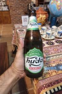 a person is holding a bottle of beer at Ngọc Trâm Homestay in A Lưới (1) +69 photos