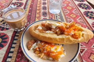 a plate of food with a sandwich on a table at Ngọc Trâm Homestay in A Lưới (1)
