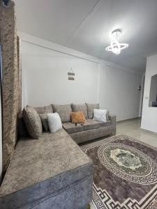 a living room with a couch and a rug at Ailynes in Diani Beach