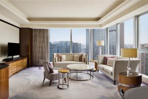 a living room with a couch and a table at Vignette Collection Palm Springs Hotel Chengdu by IHG in Chengdu
