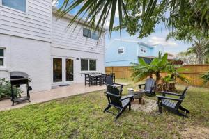 a patio with chairs and a grill in a yard at 10 Colonial Drive in Cocoa Beach