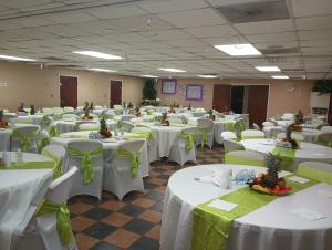 a banquet hall with white tables and green chairs at Nice Luxury Suite in Austell +3 photos