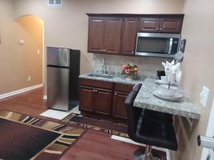 a kitchen with a sink and a refrigerator at Nice Luxury Suite in Austell