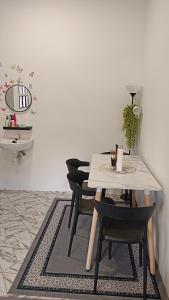 a dining room with a table and chairs at MiniHaus2Stay in Pulau Sebang