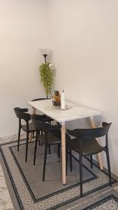 a dining room table with black chairs around it at MiniHaus2Stay in Pulau Sebang +14 photos