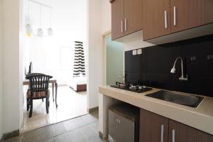 a kitchen with a sink and a counter top at Kamar Bagus in Jakarta