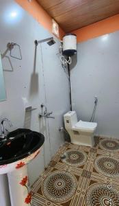 a bathroom with a sink and a toilet at shiv shankar resort and hotel in Phata