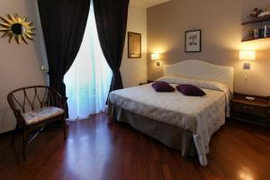 a bedroom with a bed with two pillows on it at B&B Villa Di Giorgi in Cefalù
