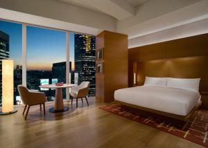 a hotel room with a bed and a table with chairs at Park Hyatt Seoul in Seoul +58 photos