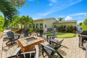 a patio with chairs and a table and a golf course at 445 Watts Way in Cocoa Beach