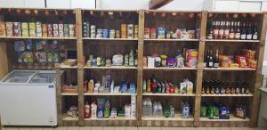 a shelf filled with lots of food and drinks at Camping Beausejour Sergines in Sergines