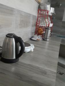a tea kettle sitting on the floor of a kitchen at Quriyat in Afā