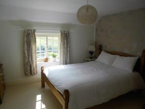 Ένα ή περισσότερα κρεβάτια σε δωμάτιο στο Villa Farm Cottage