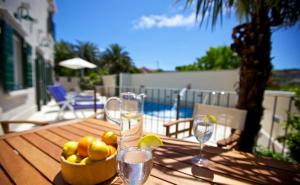 a wooden table with a bowl of fruit and glasses at Villa Angelina in Mirce +36 photos