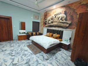 a bedroom with a large mural on the wall at The KP RESORT in Chīrgaon +47 photos
