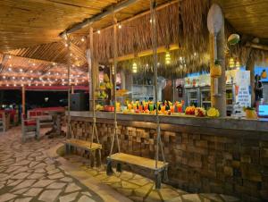 a restaurant with a bar with benches in front of it at Samui Pier Beach Front & Resort in Bangrak Beach