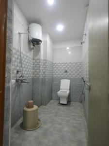 a bathroom with a toilet and a shower at Hotel Ganesha - residential in Muzaffarpur