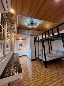 a room with two bunk beds and a wooden ceiling at KNB West Villa Inn by SMS Hospitality in Bolinao +49 photos