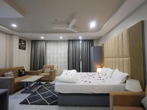 a hotel room with a bed and a couch at Hotel Ganesha - residential in Muzaffarpur