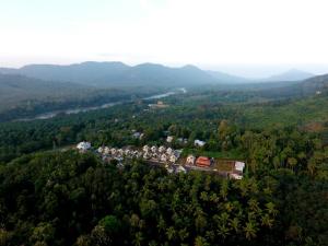 an aerial view of a group of houses in a forest at Jackroot Heritage wood villa Athirappilly in Kallana