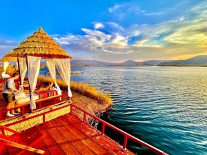 a boat on the water with people sitting on it at Titicaca Samay Lodge Perú in Puno