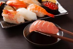 two plates of sushi with chopsticks on a table at Osaka - Hotel / Vacation STAY 65254 in Osaka