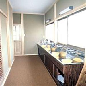 a large bathroom with two sinks and a large mirror at Tsukamoto Sou in Takayama