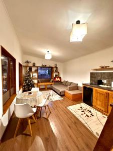 a living room with a table and a christmas tree at Eywa House in Kamenskoye Plato +90 photos