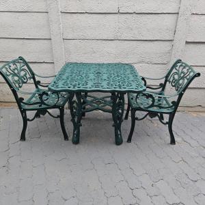 a green table and two chairs sitting next to each other at 14 Isabel Room 2 in Centurion