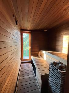 a sauna with wooden walls and a window at Saunahouse in Ilmasoo