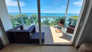 a room with a balcony with a view of the ocean at Nikki Beach Oceanfront Penthouse in Río Hato