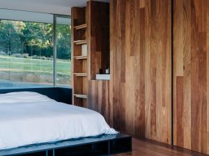 a bedroom with a bed and a large window at Triptych - The Glass House in Koonya +33 photos