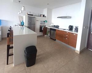 a kitchen with a counter and a island in it at Nikki Beach Oceanfront Penthouse in Río Hato