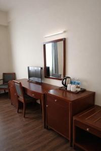 an office desk with a mirror and a telephone at Atari Inn Tawau in Tawau