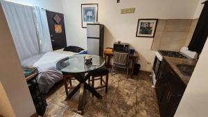 a small room with a small table and a bed at Vizcaino Departamento con cocina in Ensenada