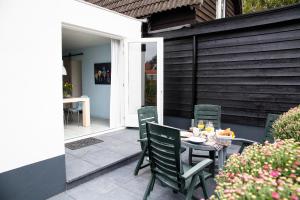 a table and chairs sitting on a patio at B&B Ons Dijkhuisje in Schuddebeurs