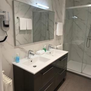 a bathroom with a sink and a shower at Thoiry Etoile Lodge, Sure Hotel Collection by Best Western in Thoiry