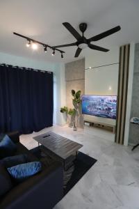 a living room with a couch and a ceiling fan at PortDickson Sakura 10Pax 3BR Glory Beach Resort Suite in Port Dickson