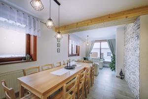 a kitchen and dining room with a wooden table and chairs at Chata Radiva in Žiar