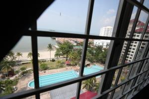 a view from a window of the pool at PortDickson Sakura 10Pax 3BR Glory Beach Resort Suite in Port Dickson