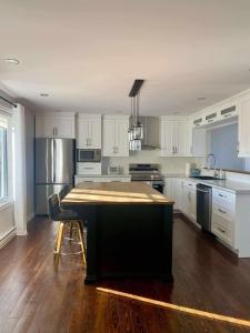 a kitchen with a island in the middle of it at L'Anseau-Persil in Rivière-du-Loup +26 photos