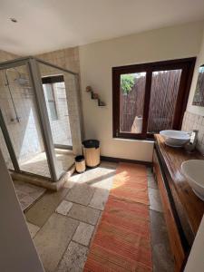 a bathroom with a shower and a sink at Luxury Villa at Elements Golf Course - Bela Bela in Warmbaths +10 photos
