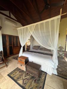 a bedroom with a bed with a canopy at Luxury Villa at Elements Golf Course - Bela Bela in Warmbaths