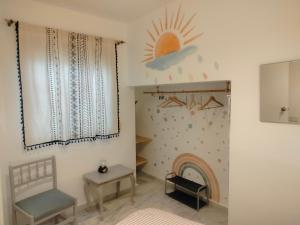 a room with a bed and a chair and a fire place at Casa Fuente del Caño in Casarabonela