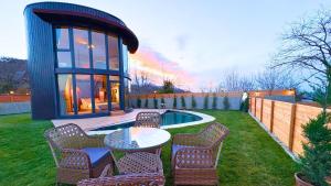 a backyard with a table and chairs and a building at Dream River Sapanca in Sapanca