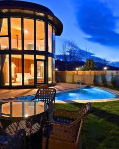 a patio with a table and chairs next to a pool at Dream River Sapanca in Sapanca