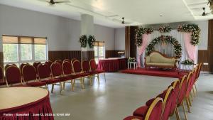 a room with rows of chairs and a wedding altar at Hotel RKD Inn in Guwahati