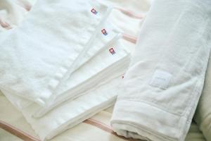 a pair of white socks sitting on top of a bed at Nagi Takamatsu 702 in Takamatsu