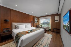 a hotel room with a large bed and a tv at Jolie Vue Boutique Hotel Guilin (near Elephant Trunk Hill) in Guilin