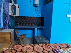 a group of pizzas sitting next to a blue wall at Himalayan Hostel in McLeod Ganj